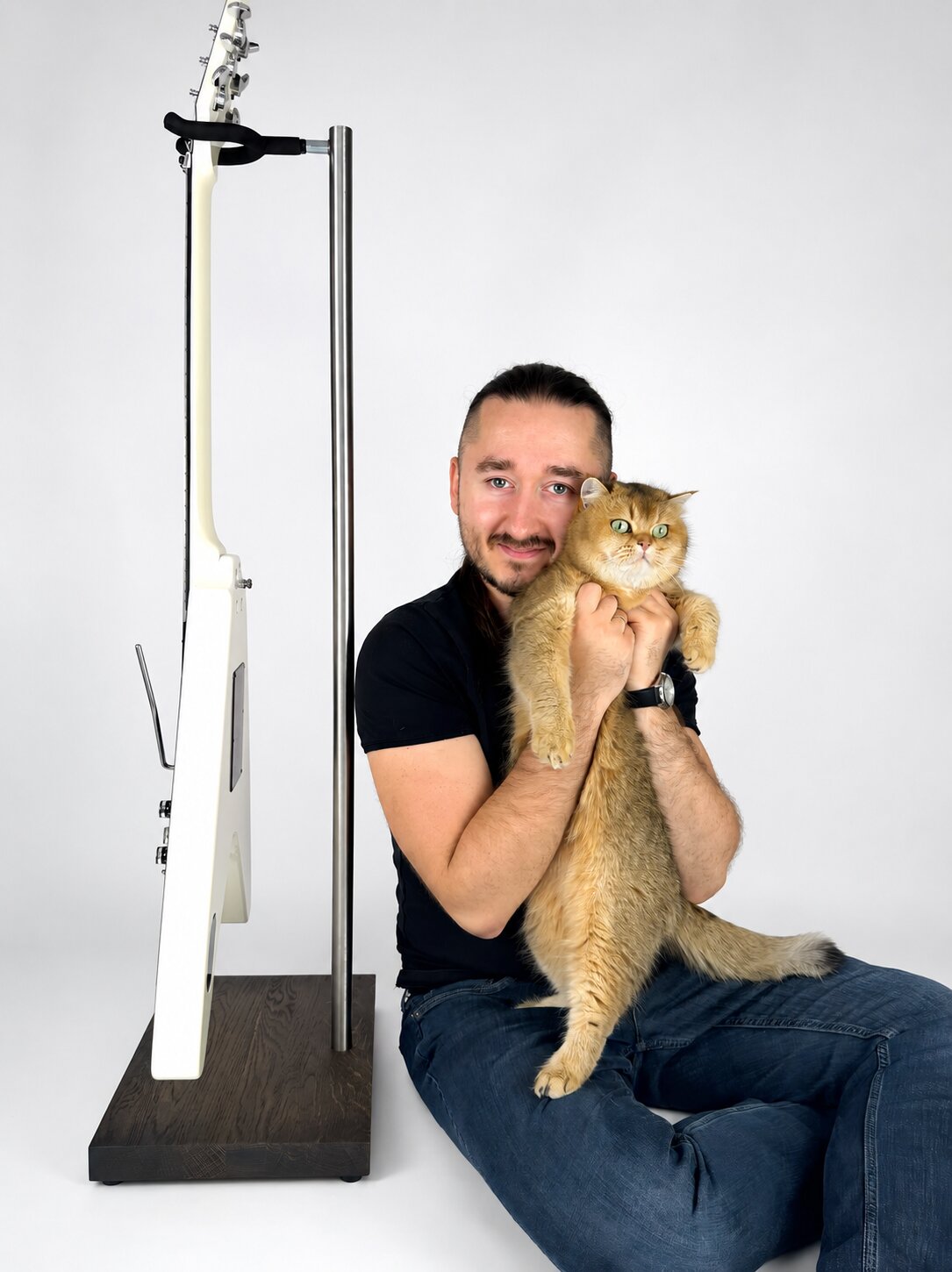 Maker presenting a handcrafted wooden guitar stand with an electric guitar