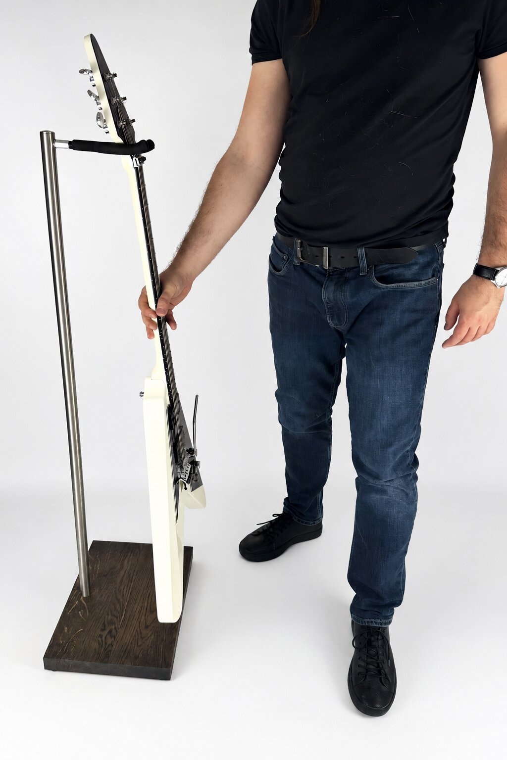 Side view of a premium handmade wooden stand holding an electric guitar