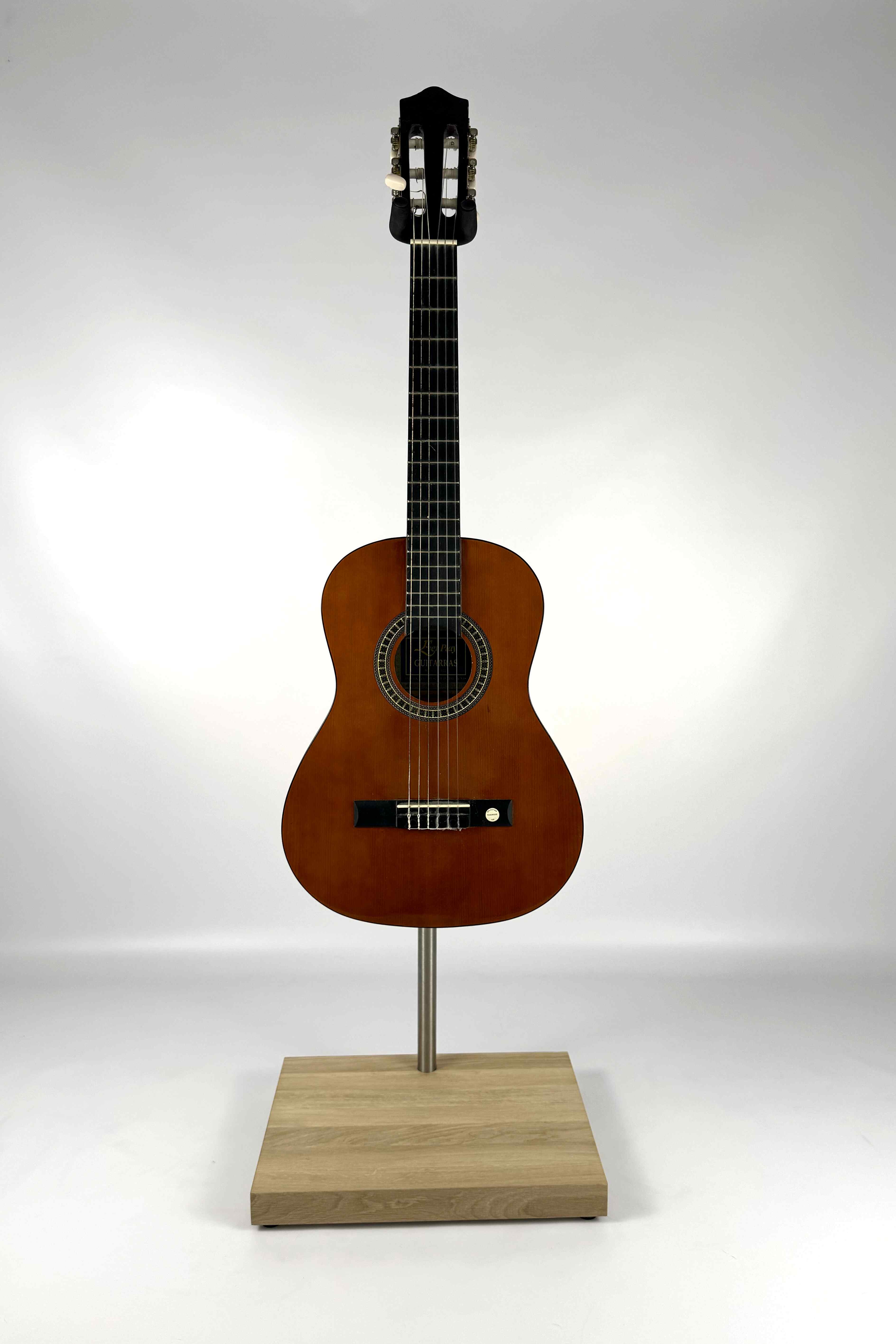 Premium wooden guitar stand with a natural finish holding a guitar, front view