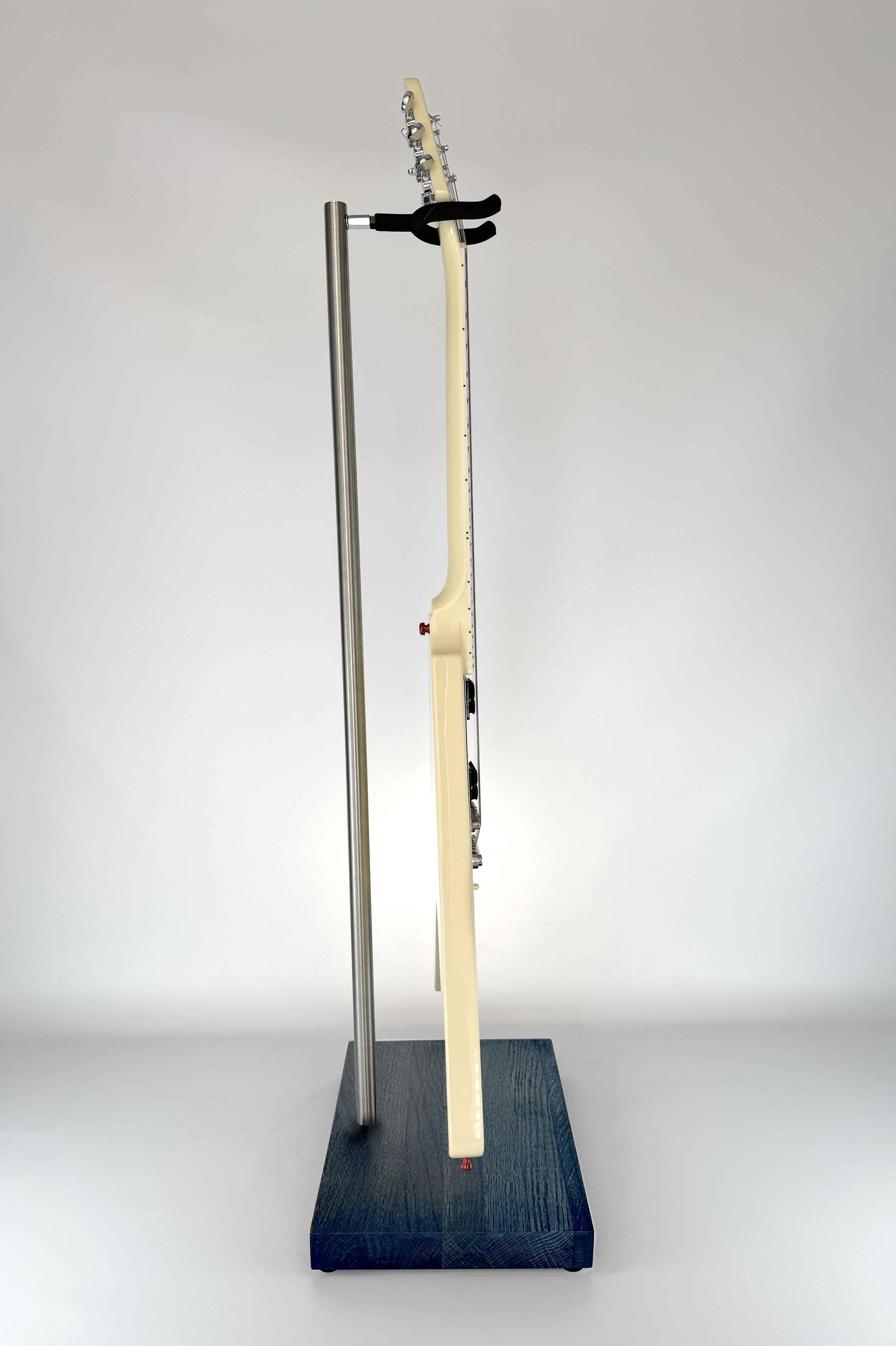 Stable wooden guitar stand with a blue finish holding a guitar, side view showing secure instrument support